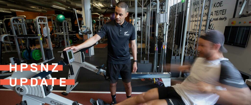 HPSNZ team member watches athlete at rowing machine