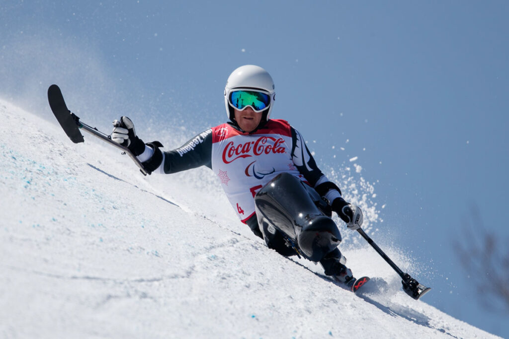 Corey Peters powering down a slope on the sitski